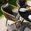 An outdoor patio setting with a dining table and chairs. Produktbild-Vorschau
