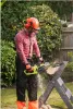 A man is using an electric chainsaw to cut a log in a garden. Anteprima dell’immagine prodotto