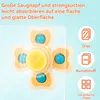A close-up of a suction cup fidget spinner toy with text overlays describing its features and compatible surfaces. Produktbild-Vorschau