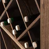 A close-up view of a wooden wine rack filled with wine bottles. Voir les images du produit