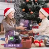 Two children opening an advent calendar by a Christmas tree. Produktbild-Vorschau