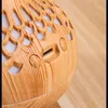 Close-up view of a part of an aroma diffuser with a wood-grain finish. Produktbild-Vorschau