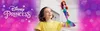 A young girl is happily holding up a Disney Princess Ariel mermaid doll against a blurred purple and pink bokeh background. Anteprima dell’immagine prodotto