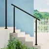 A black handrail is installed on a set of outdoor stairs, with a blue wall and a white picket fence in the background. Produktbild-Vorschau
