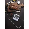 A cooked steak on a wooden cutting board with spices and a digital thermometer. Voir les images du produit