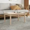 A wooden coffee table is placed in front of a sofa in a living room setting. Náhled obrázku produktu