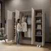 A woman is standing in front of an open wardrobe, holding a white shirt. Produktbild-Vorschau