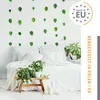 A bedroom scene with a bed and plants, decorated with leaf stickers on the wall. Produktbild-Vorschau