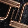 A close-up view of several copper-colored faucet handles with ribbed detailing, arranged on a dark, textured surface. Náhľad obrázku produktu