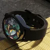 A smartwatch with a colorful watch face is placed on a textured surface. Anteprima dell’immagine prodotto