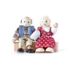 Two wooden dolls, a man and a woman, sitting on a wooden bench. Produktbild-Vorschau