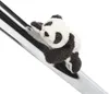 A plush panda toy is clinging to a shiny, metallic pole. Produktbild-Vorschau