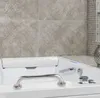 A close-up view of a bathtub with a grab bar and faucet. Anteprima dell’immagine prodotto