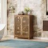 A bathroom scene with a wooden cabinet, bathtub, and rug. Anteprima dell’immagine prodotto