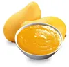 Two whole mangoes and a bowl of mango puree are shown against a white background. Podgląd zdjęcia produktu