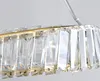 A close-up view of a gold-colored chandelier with clear crystal elements. Anteprima dell’immagine prodotto