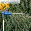 A blue and gray telescopic hedge trimmer is shown cutting through green foliage. Produktbild-Vorschau