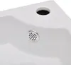 A close-up view of a white sink with a drain and an overflow hole. Náhľad obrázku produktu