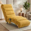 A yellow chaise lounge chair is shown in a living room setting with a floor lamp, a side table with a lamp, and a potted plant. Voir les images du produit