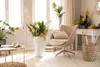 A bright and airy living room with several plants, a chair, and a side table. Náhled obrázku produktu