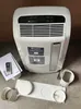 A portable air conditioner unit and its accessories are laid out on a gray surface. Produktbild-Vorschau