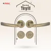 A marketing image showcasing a set of bronze door handles with a house-shaped graphic and text. Produktbild-Vorschau