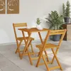 A wooden table and chairs set on a patio. Produktbild-Vorschau