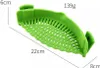 A green silicone strainer with dimensions indicated by text overlays. Produktbild-Vorschau