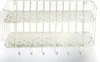 A white metal wall shelf with two tiers and six hooks underneath, displayed against a white background. Náhľad obrázku produktu