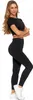 A woman wearing black leggings and a black crop top, posing against a white background. Produktbild-Vorschau