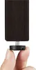 A person's fingers are holding a black screw-on foot for a piece of furniture. Produktbild-Vorschau