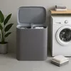 A laundry basket and washing machine in a laundry room. Produktbild-Vorschau