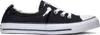 A black Converse sneaker with white laces and a white sole, shown from the side. Voir les images du produit