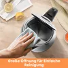 A hand is cleaning the inside of a stainless steel kettle with a blue cloth. There are lemons on the table. Produktbild-Vorschau