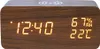 A digital alarm clock with a wood-grain finish displays the time, humidity, and temperature. Produktbild-Vorschau