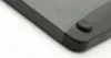 A close-up view of the corner of a cutting board, showing its textured surface and a rubber foot. Produktbild-Vorschau