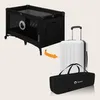 A black travel crib is shown next to a white suitcase and a black carrying bag, with an orange arrow indicating the crib can be packed into the bag for travel. Anteprima dell’immagine prodotto