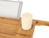 A close-up view of a bamboo bath tray with a candle in a holder and a translucent screen. Náhľad obrázku produktu