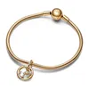 A close-up studio shot of a gold Pandora bracelet with a Scorpio zodiac charm. Podgląd zdjęcia produktu