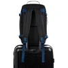 The back of a black and blue backpack is placed on top of a black suitcase. Náhled obrázku produktu