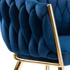 Close-up of a blue velvet chair with gold metal accents. Náhled obrázku produktu