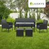 A polyrattan garden furniture set is arranged on a green lawn in a backyard setting. Produktbild-Vorschau