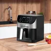 An air fryer sits on a wooden countertop in a kitchen. Náhled obrázku produktu