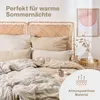 A neatly made bed with several pillows and a duvet, in a bedroom setting with a piece of art on the wall. Produktbild-Vorschau