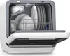 An open compact dishwasher filled with white dishes. Náhľad obrázku produktu