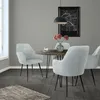 A dining set with four chairs around a round table in a room. Náhľad obrázku produktu