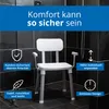 A white shower chair with a backrest and armrests is shown in a tiled shower stall. Anteprima dell’immagine prodotto