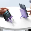 Two smartphones are shown on a white table, each attached to a purple power bank that doubles as a stand. Podgląd zdjęcia produktu
