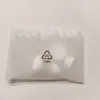 A white plastic bag with a recycling symbol and text. Voir les images du produit