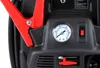 A close-up view of a car jump starter device, showing a pressure gauge, a switch, and a red jumper cable clamp. Podgląd zdjęcia produktu